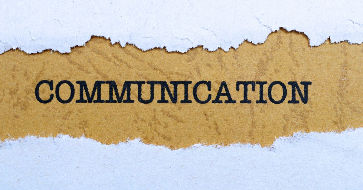 Driving Success Through Communication: Sheet of paper with a section torn away to reveal the word "Communication".