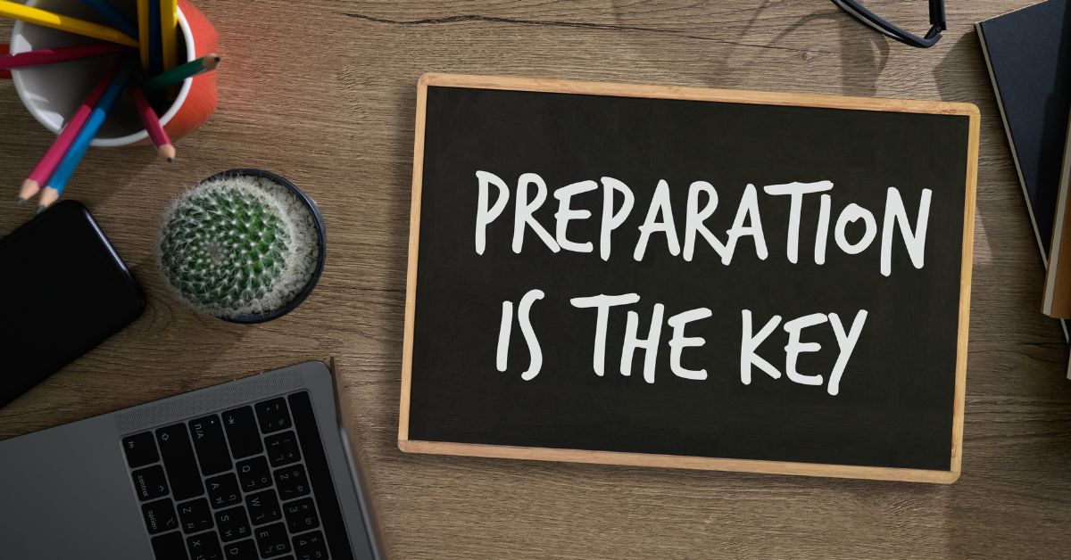 Salary Negotiation: Chalkboard on a desktop. Chalkboard reads "Preparation is the Key".