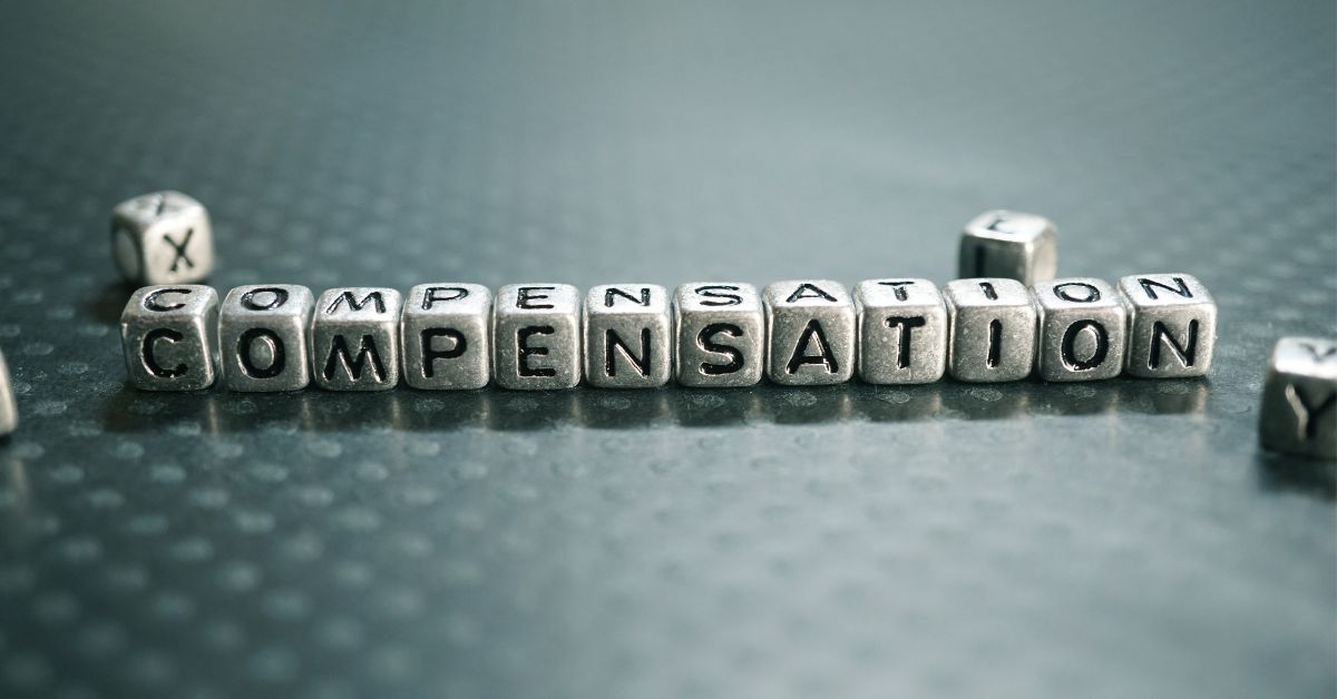 Total Compensation: Gray background with a series of small metal blocks spelling out the word "Compensation".