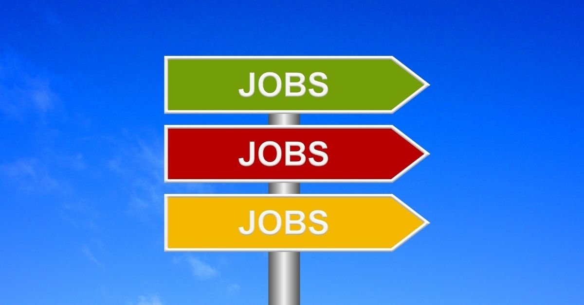 Us Job Market Adds 184000 Jobs In March: Road sign with multi-colored arrows reading "Jobs, Jobs, Jobs".