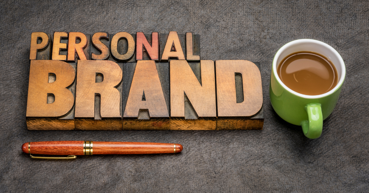 Developing A Personal Brand: Metallic letters spelling out "Personal Brand" sit on a metal desktop next to a full coffee mug.