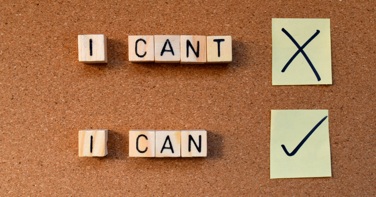 Stay Positive And Persistent In Your Job Search: Wooden letter blocks on a corkboard spelling "I CAN" and "I CAN'T" with "I CAN" marked with a check. This visual emphasizes the power of positive thinking and staying persistent in the job search.