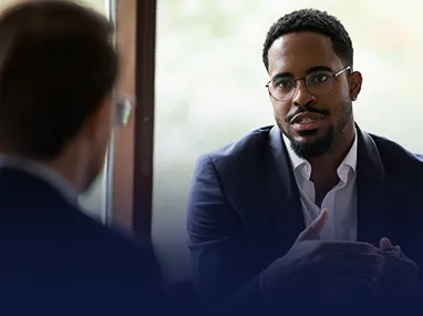 African American Professional Discussing Office