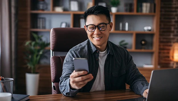 Asian Man Looking At Phone