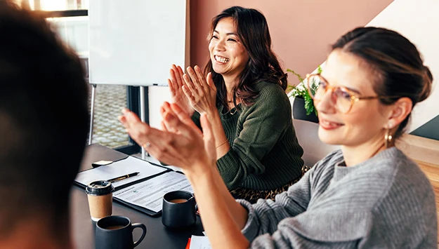 Business People Applauding During Office Meeting