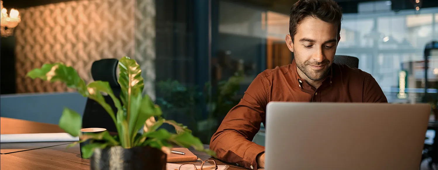 Professional Young Adult Man Using Laptop Alone In Office