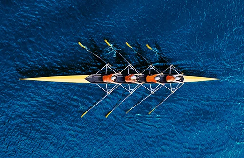 Team Rowing In Sea